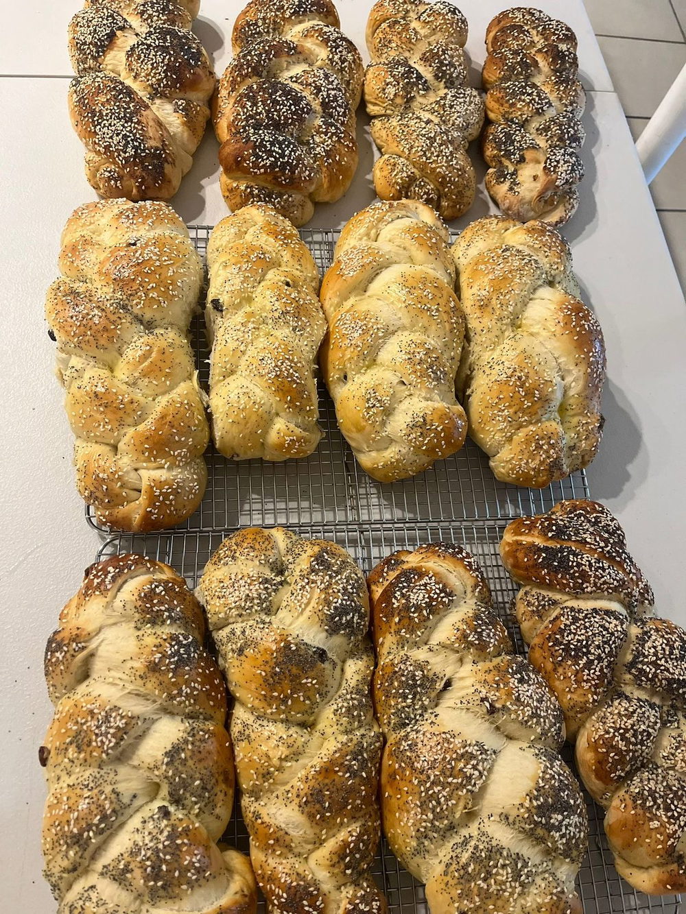 Finished braided challahs cooling on a rack