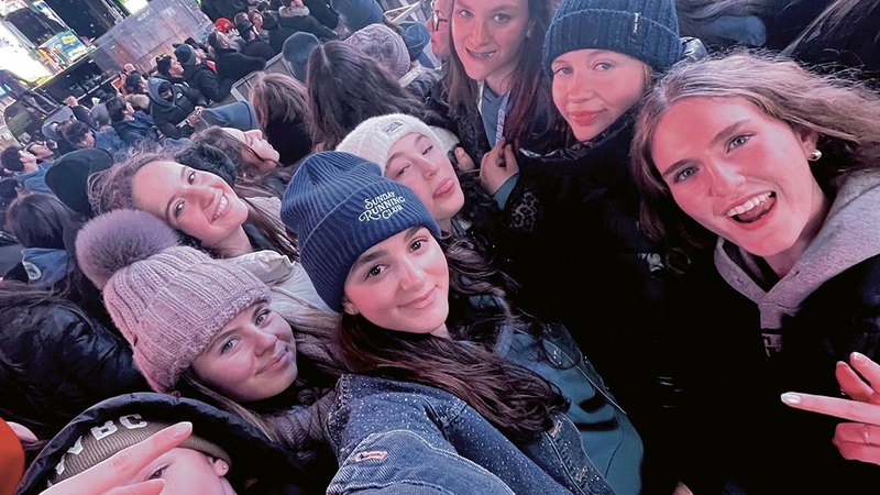 CTeen girls bundled up together in Times Square at the Shabbaton