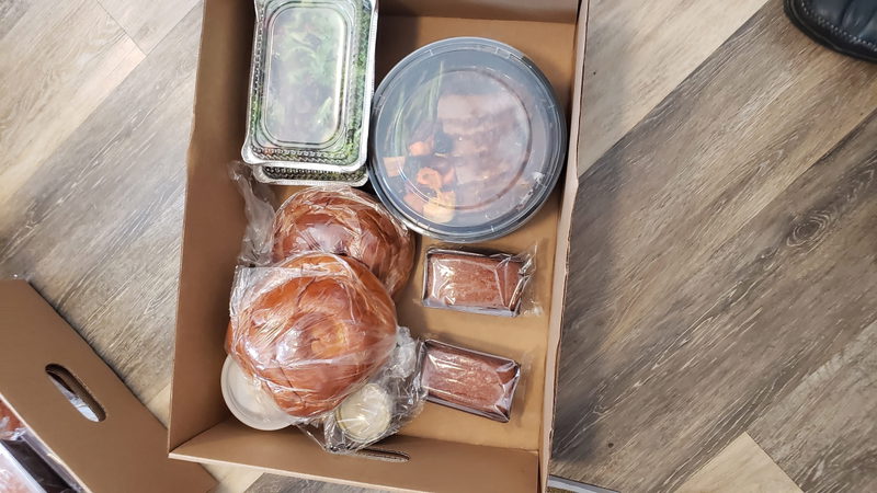 Kosher meal delivery box with challahs, salads and prepared foods