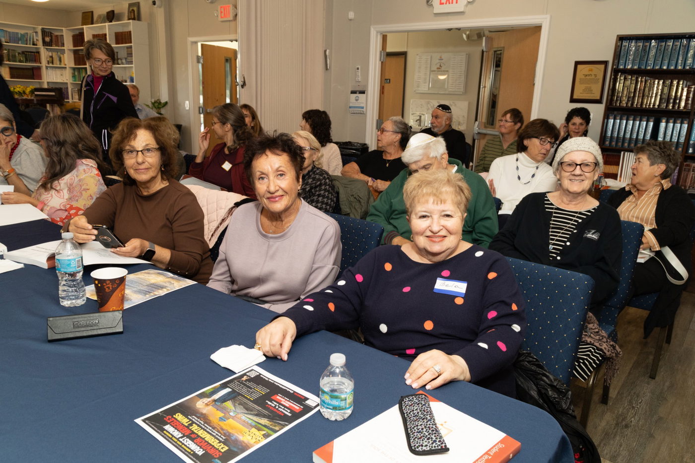 Book club members in discussion with books open
